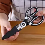 A chef holding kitchen scissors.